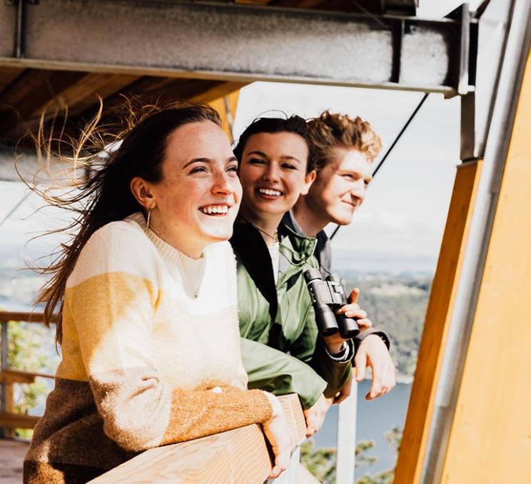 A group of friends look out over the edge of the Malahat SkyWalk in Victoria, BC