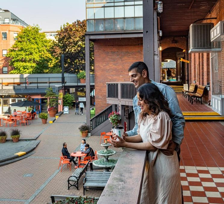 A couple enjoys a coffee at Market Square in Victoria, BC