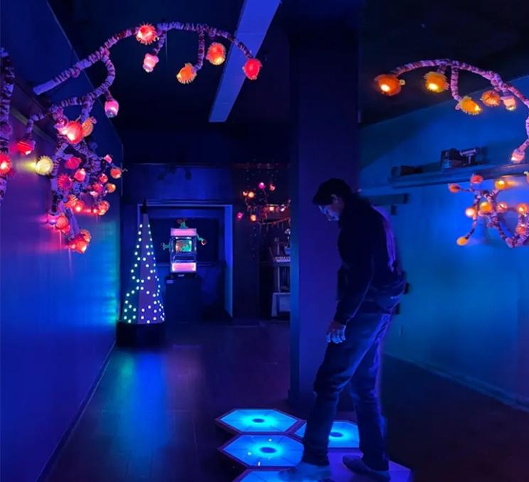 A man explores an interactive exhibit at Monkey C's Artcade in Victoria, BC