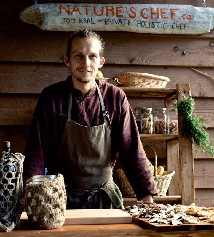 man standing in front of a cutting board