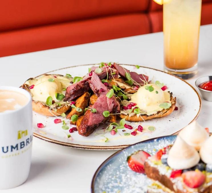 Duck eggs benedict, coffee, and a fruit-filled French toast at OEB Breakfast Co. in Victoria, BC