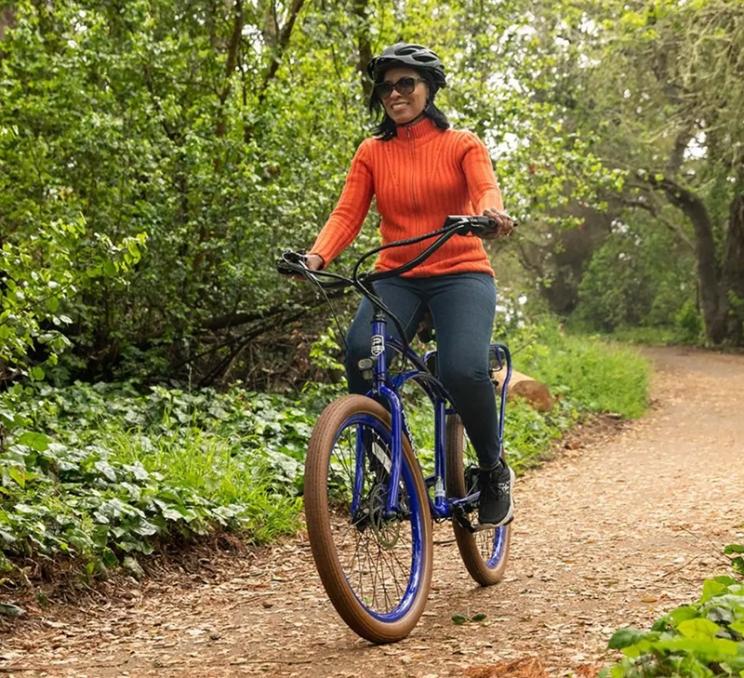 A woman rides a Pedego rental bike in Victoria, BC