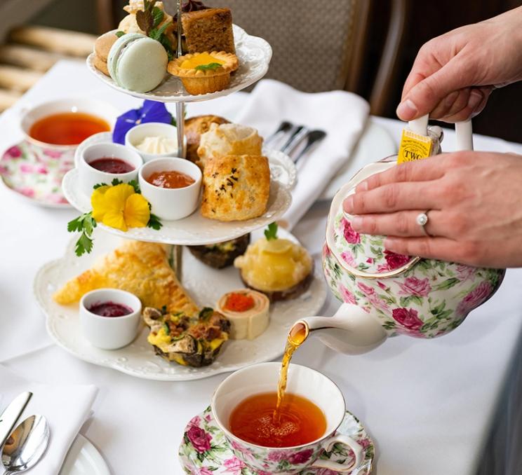 A woman pours tea during afternoon tea at the Pendray Tea house in Victoria, BC