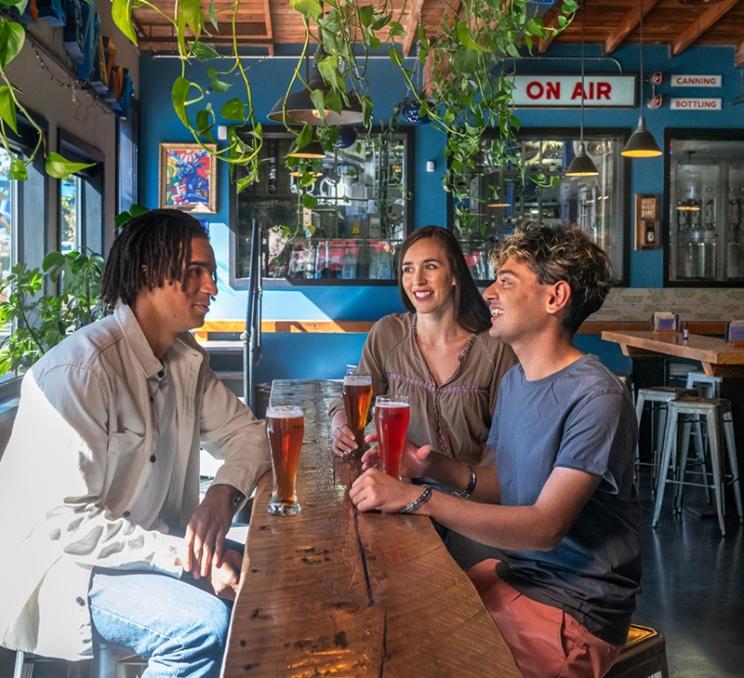 A group of friends enjoy beers at Phillips Brewing & Malting Co. in Victoria, BC