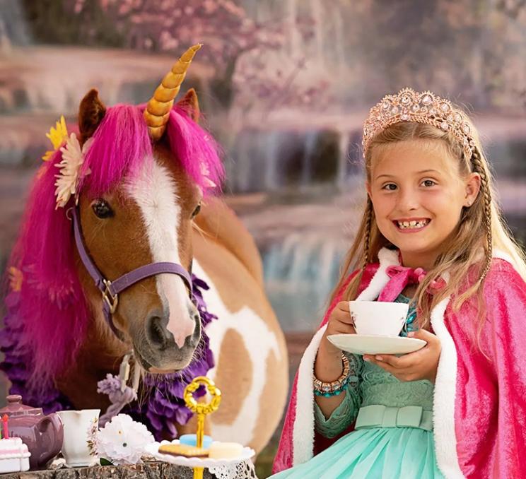 A girl and a pony enjoy tea at Pipsqueaks and Ponies in Victoria, BC