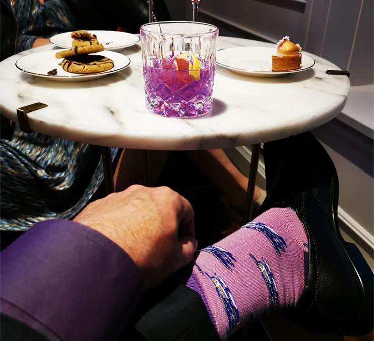 A gentleman enjoys a cocktail at the Q Bar at the Fairmont Empress in Victoria, BC