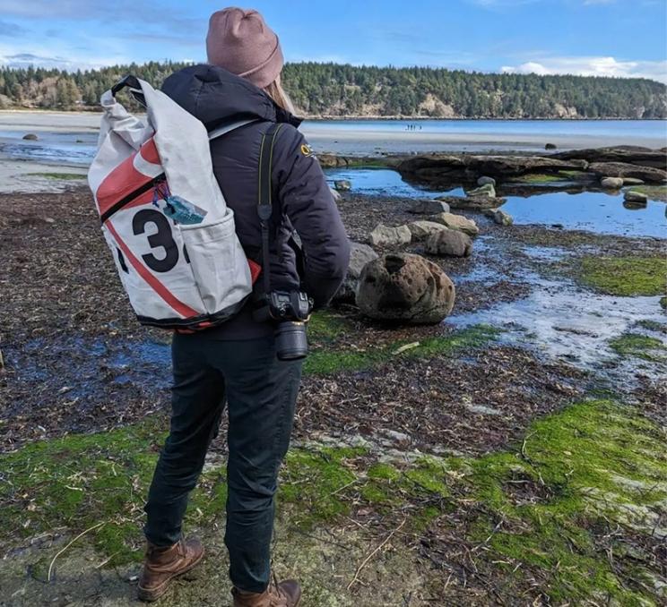 A woman wears a backpack made from a sail in Victoria, BC