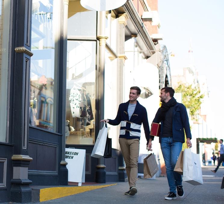 A couple goes shopping down Lower Johnson Street in Victoria, BC