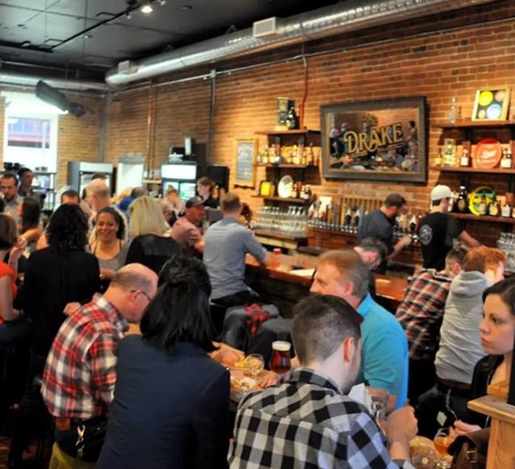 A social crowd enjoys an evening of food and drinks at The Drake Eatery in Victoria, BC