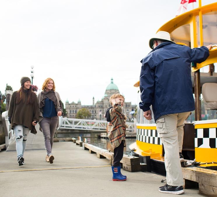 A child speak with a Harbour Ferry Captain at the Empress Dock in Victoria, BC