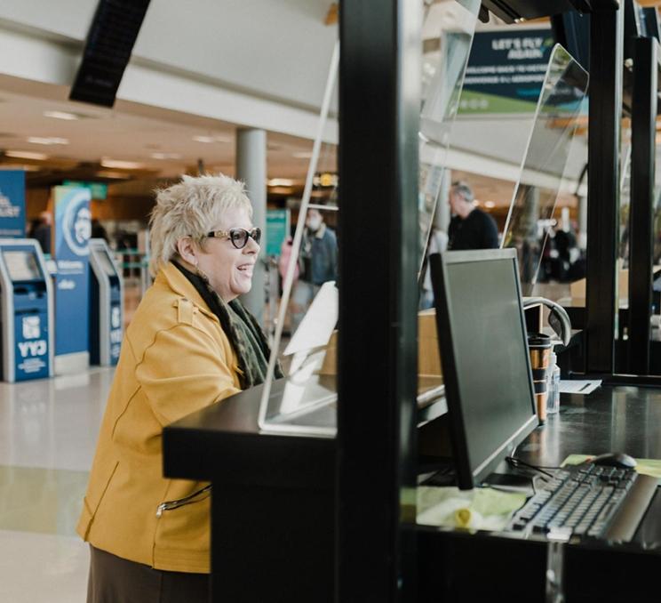 A woman checks in at YYJ - Victoria International Airport in Victoria, BC