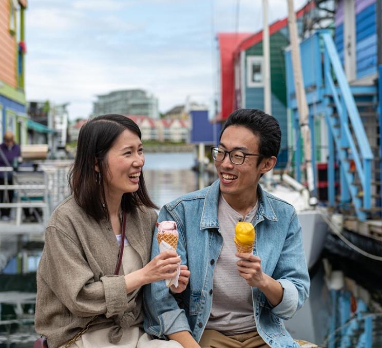 A couple enjoys ice cream cones on Fisherman's Wharf in Victoria, BC