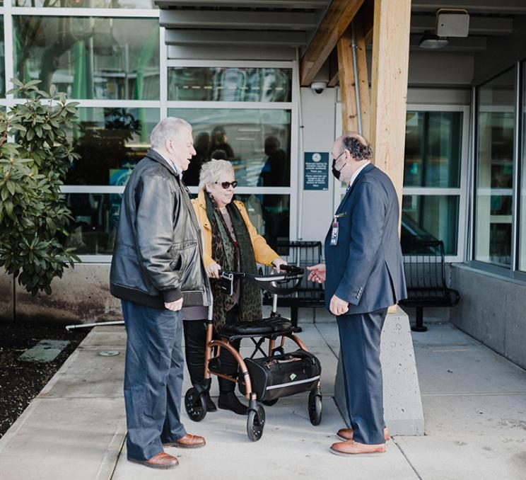 A couple uses curbside assistance at YYJ - Victoria International Airport in Victoria, BC