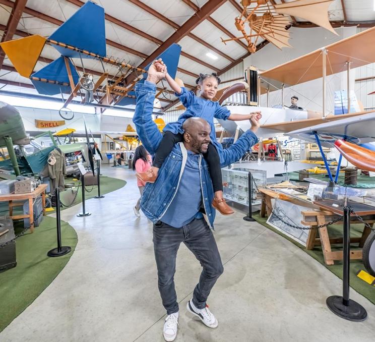 A father and daughter soar through the BC Aviation Museum in Victoria, BC