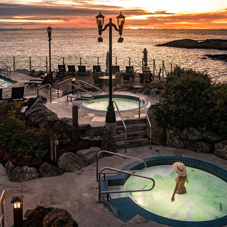 A woman soaks in a seaside mineral pool at the Oak Bay Beach Hotel in Victoria, BC