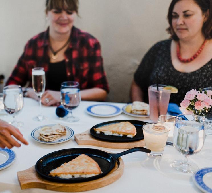 Friends dine at Ithaka Greek Restaurant in Victoria, BC