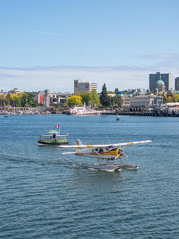 A Kenmore Air seaplane taxis in Victoria BC's Inner Harbour