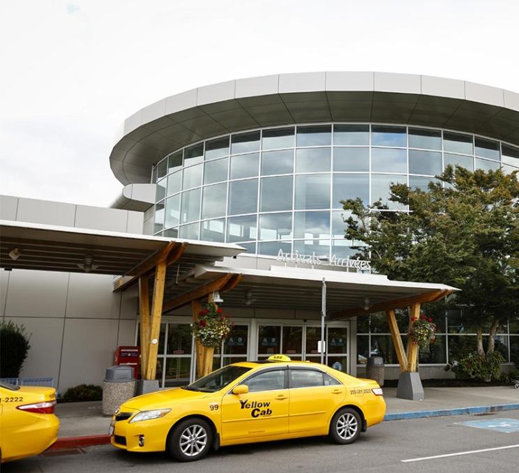 A taxi waits for a curbside pick-up at YYJ - Victoria International Airport in Victoria, BC