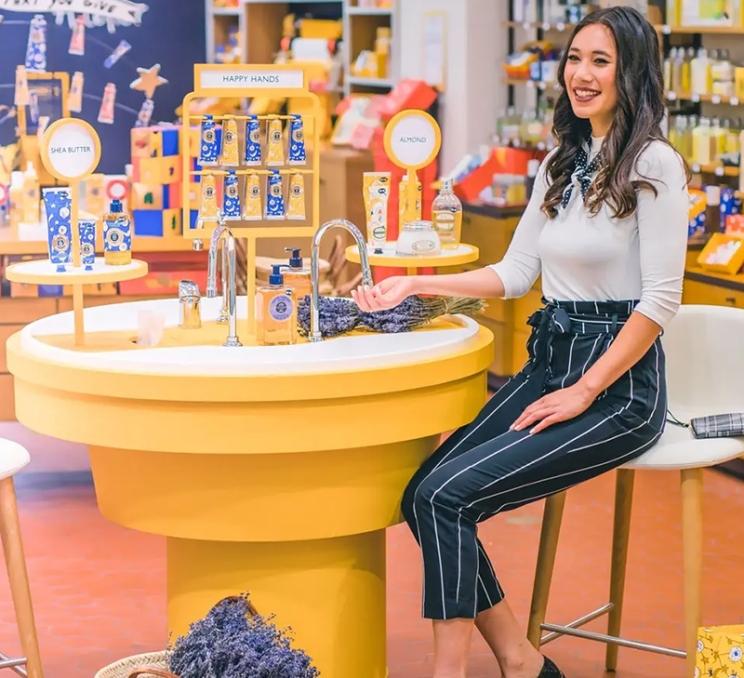 A woman tests scented beauty products in a store at the Bay Centre Shopping Centre in Victoria, BC