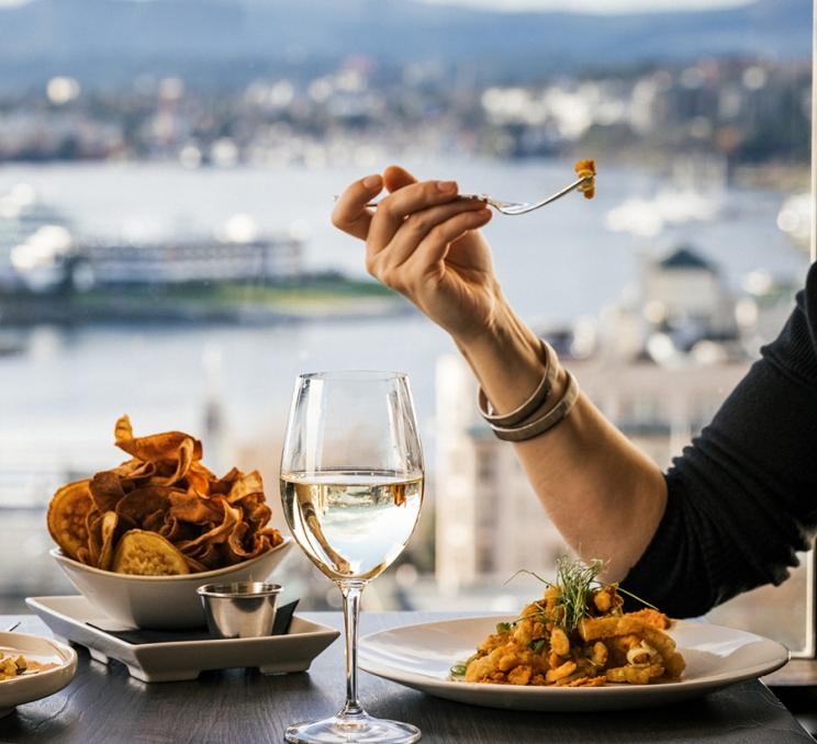 A couple enjoys dinner with a view at Vista 18 Restaurant & Lounge in Victoria, BC