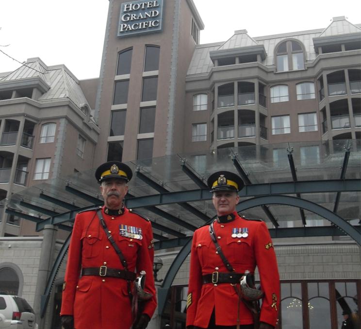 A pair of RCMP officers stand outside the Hotel Grand Pacific in Victoria, BC