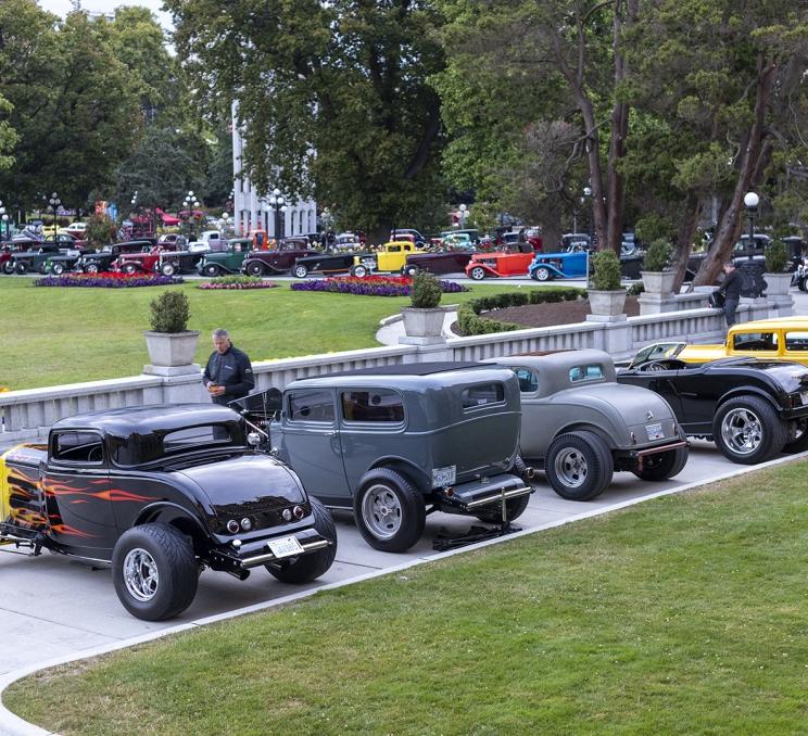 Classic Northwest Deuce Days cars lined up in front of the Legislative Buildings in Victoria, BC.