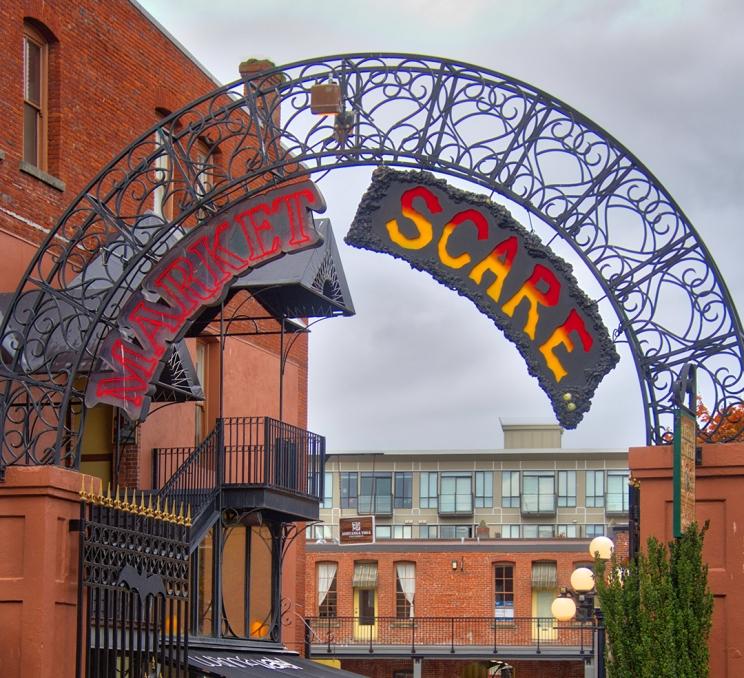 A sign that reads Market Scare hangs overhead Market Square a historic shopping district in downtown Victoria, BC