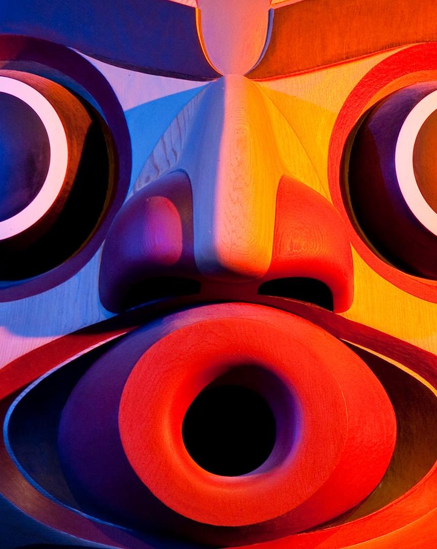 A carved face of a totem pole