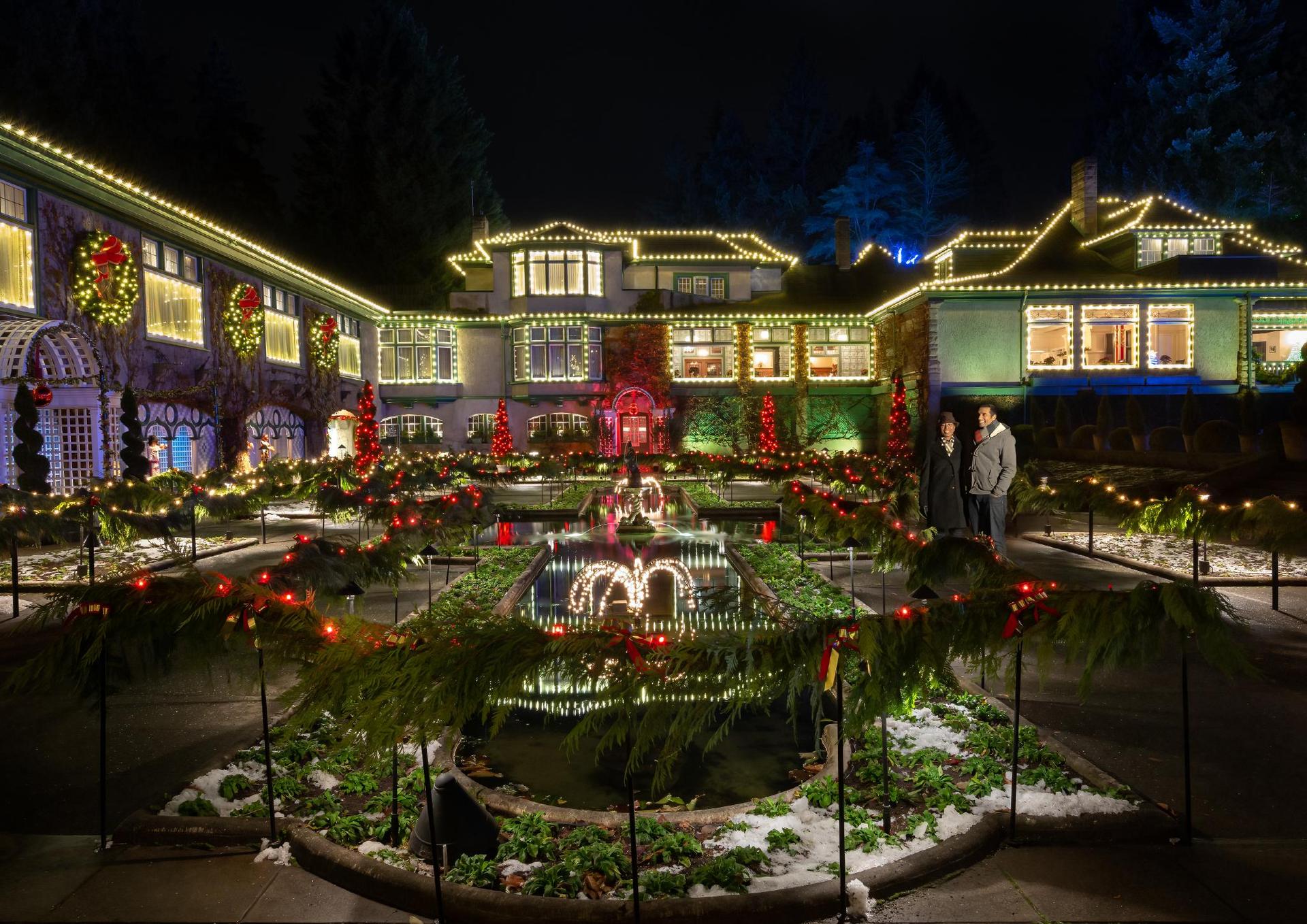 A couple explores the light display at The Butchart Gardens in Victoria, BC