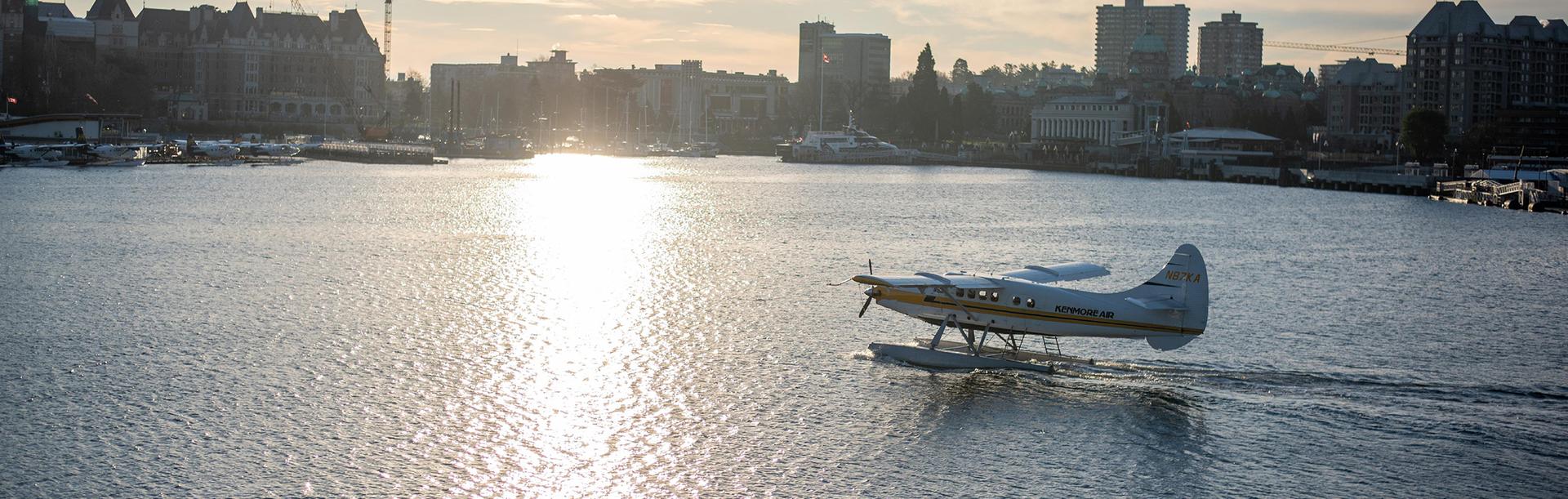 Kenmore Air seaplane flight lands on the Inner Harbour in Victoria, BC