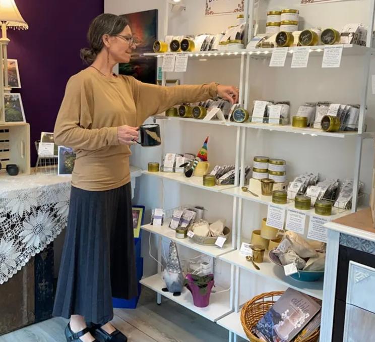 A woman browses a selection of teas at Island Elixir Tea Company in Greater Victoria, BC