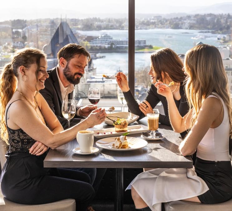 A group of four dining at Vista 18 at Chateau Victoria's rooftop restaurant for Dine Around 2026.